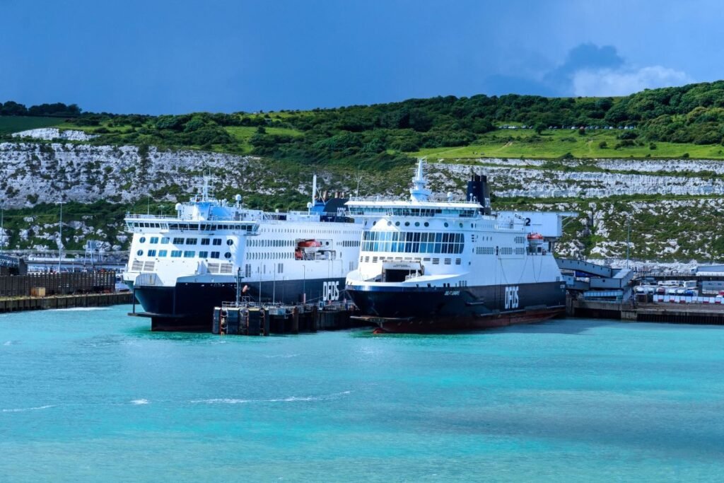 Ferries in the port of Dover with the white cliffs behind